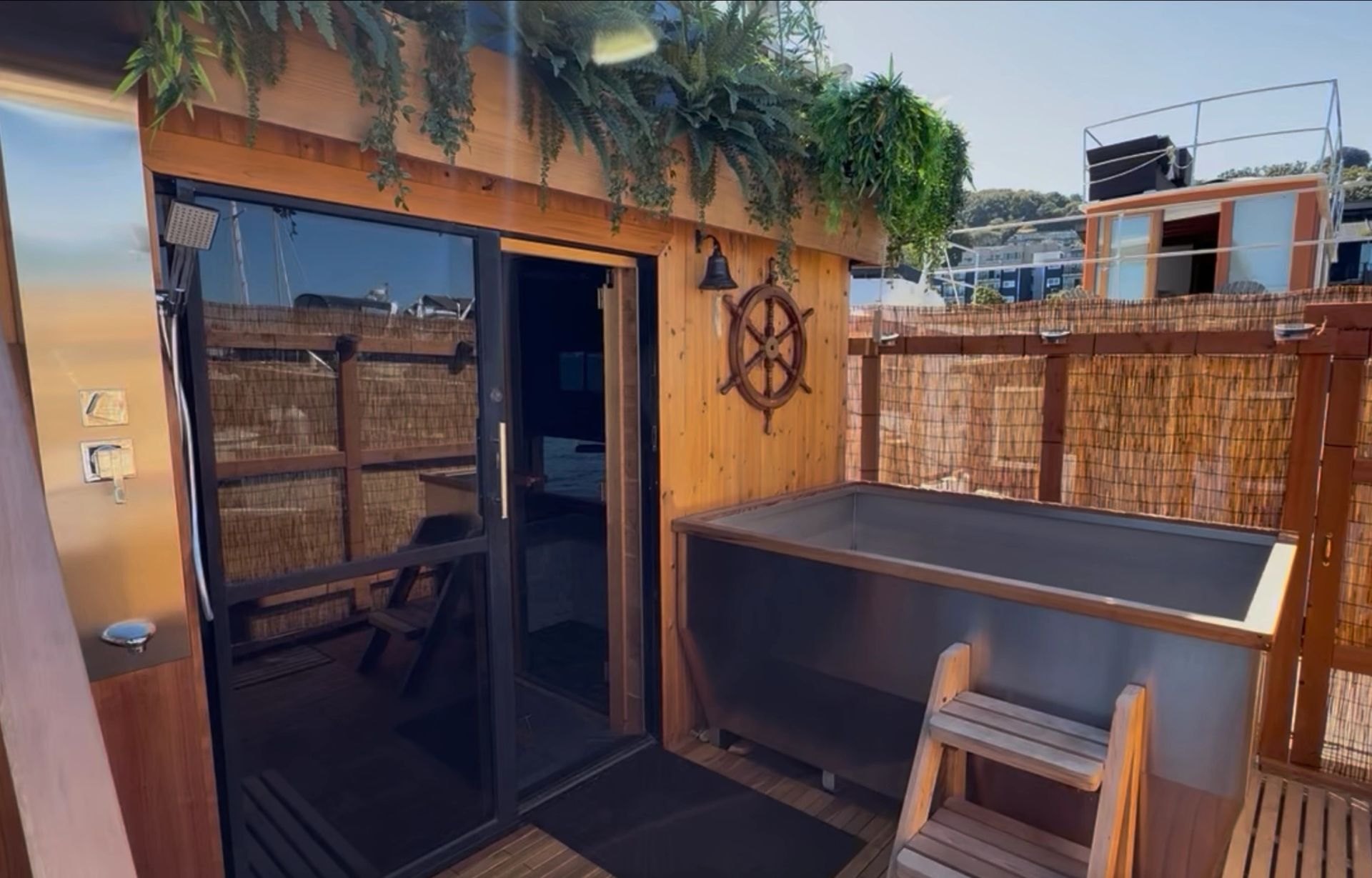 Banya Boat deck entrance with glass doors, cedar walls, and the cold plunge
